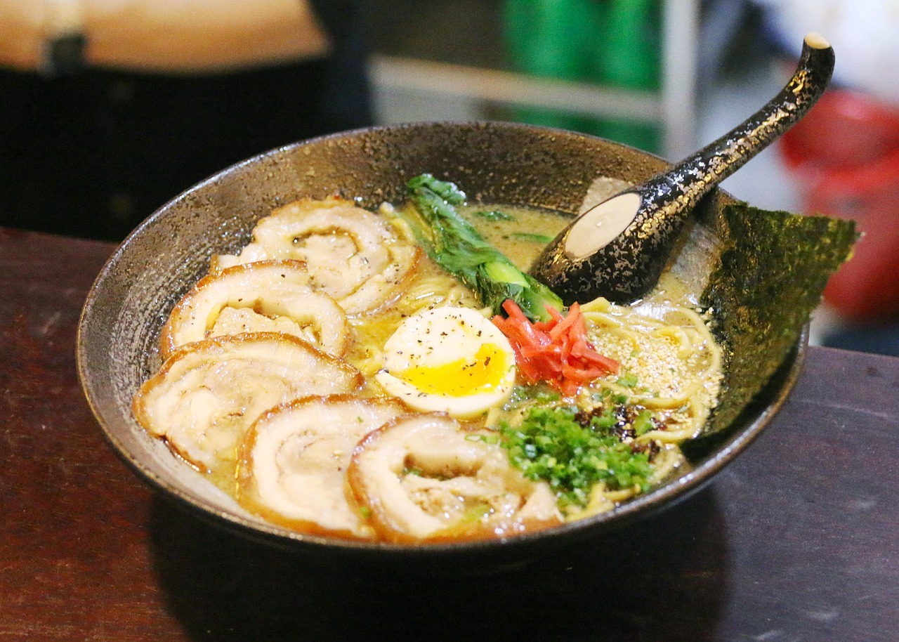 ramen with meat, eggs, and vegetables in a bowl