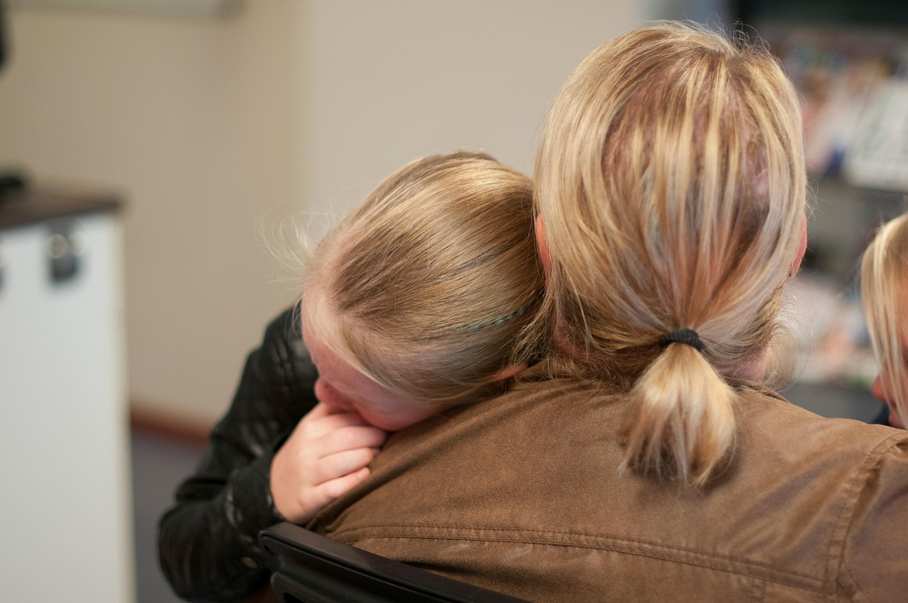 girl hugging her mother